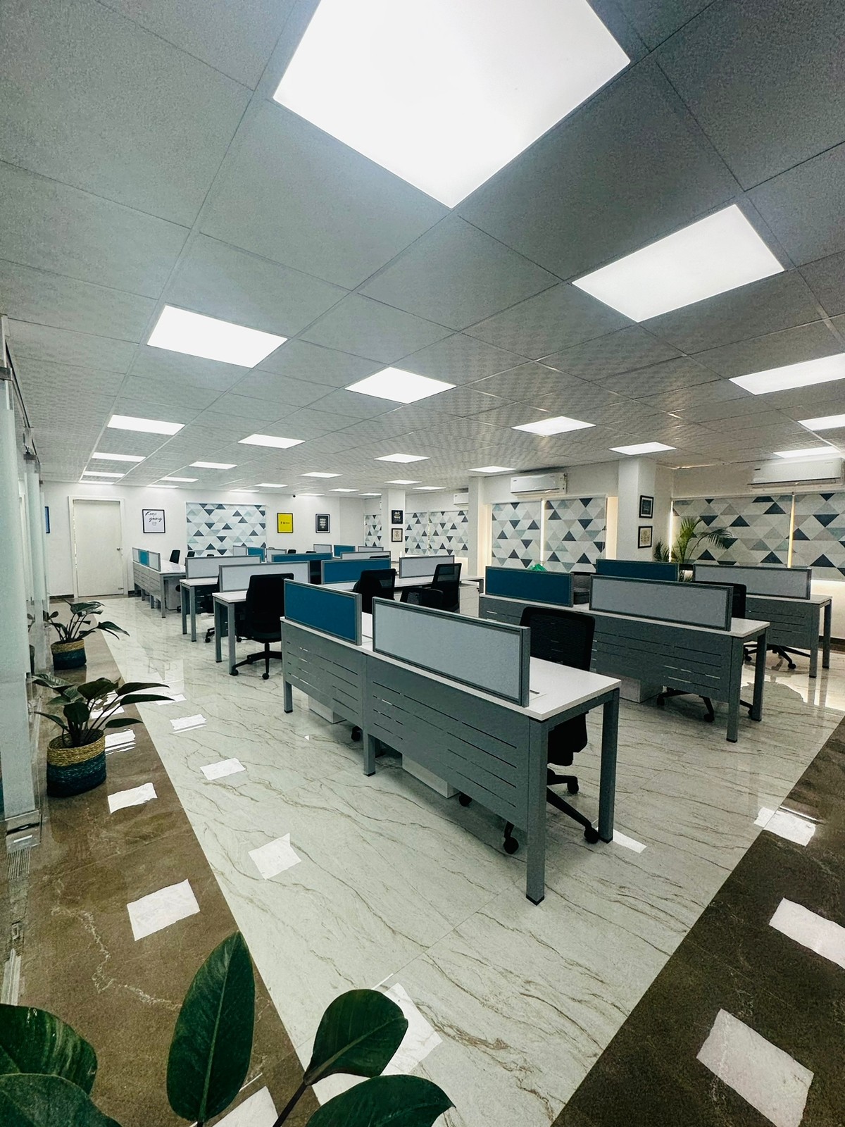 Office workstations with blue and grey desk screens